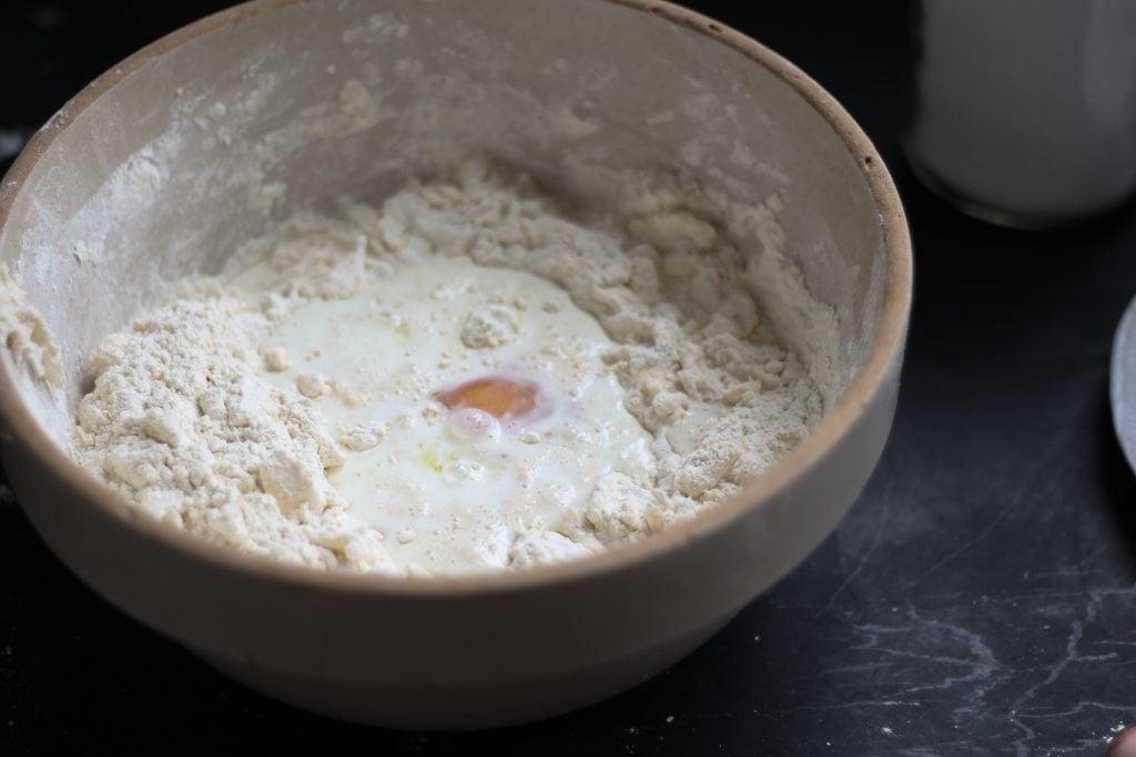 milk and egg in biscuit dough
