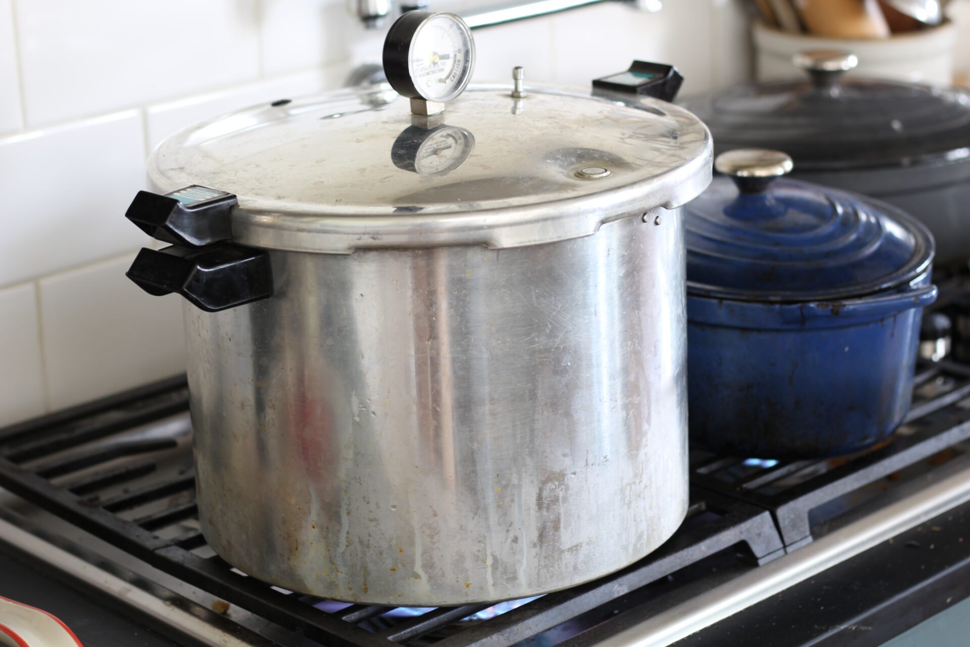 a metal pressure canner on the stove 