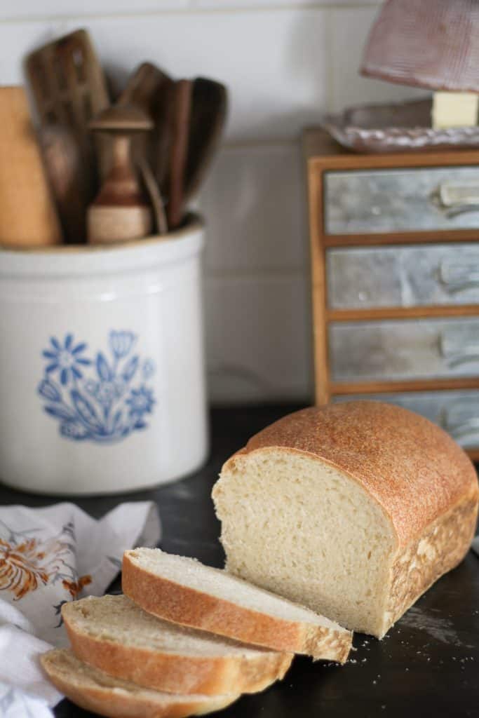sourdough sandwich bread with 3 slices stacked in front.