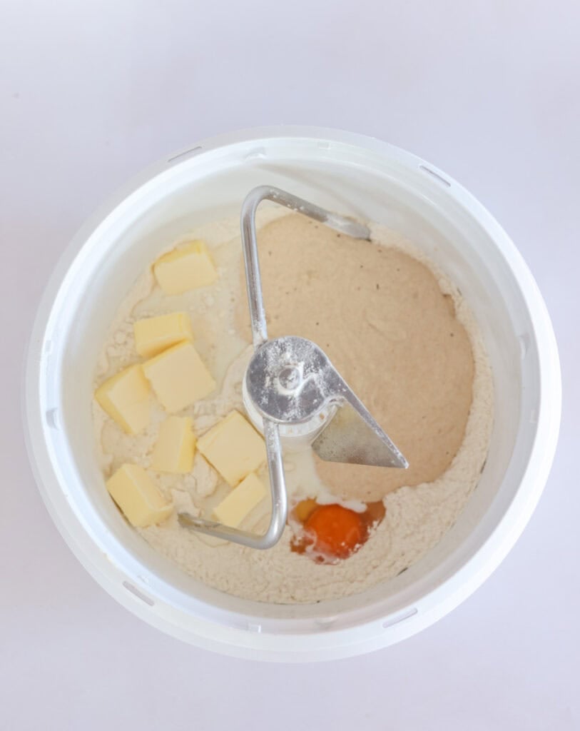 sourdough starter and wet ingredients added to dry ingredients for cinnamon roll dough.