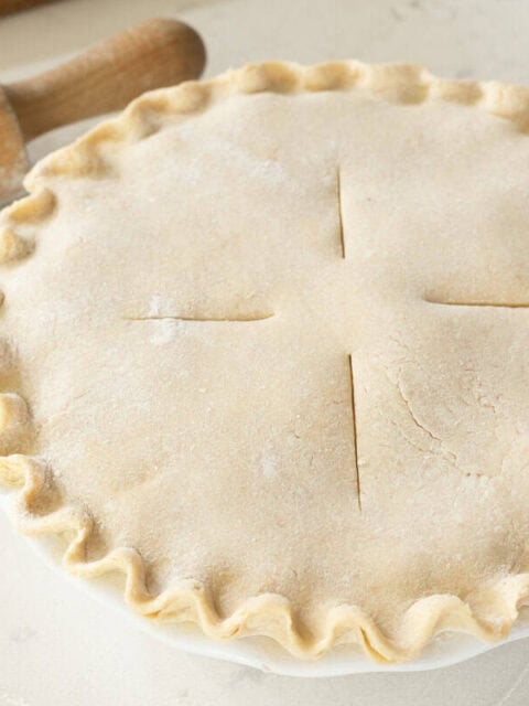 sourdough pie crust crimped and scored in pie plate.