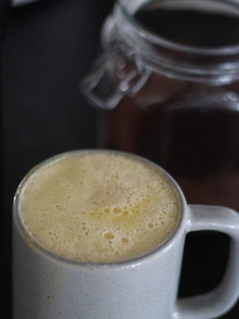 creamy egg yolk coffee in gray mug.