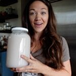holding a gallon of homemade laundry soap