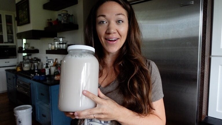 holding a gallon of homemade laundry soap
