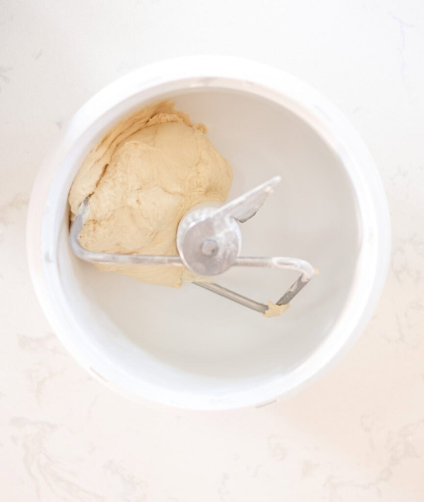sourdough sandwich bread dough kneaded in mixing bowl.