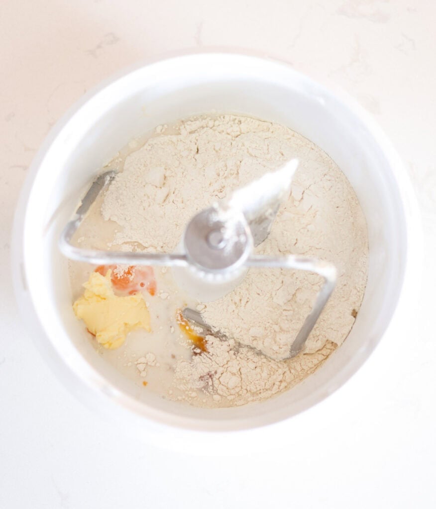 sourdough sandwich bread ingredients in bowl of stand mixer.