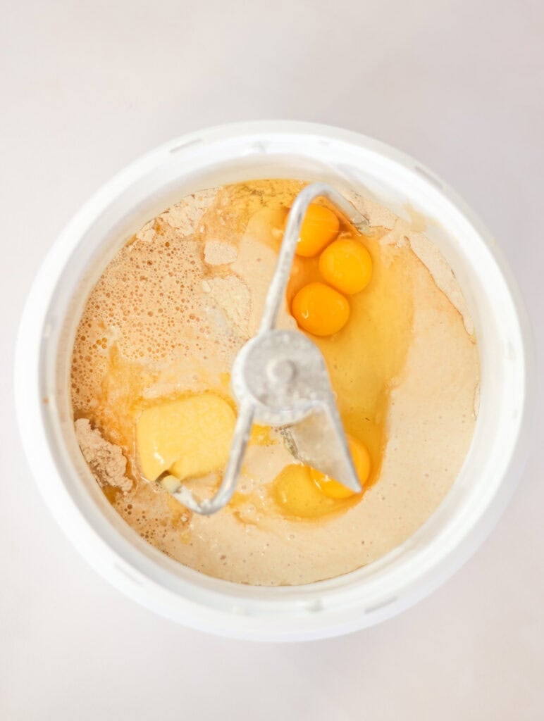 sourdough pullman loaf ingredients added to a mixing bowl.