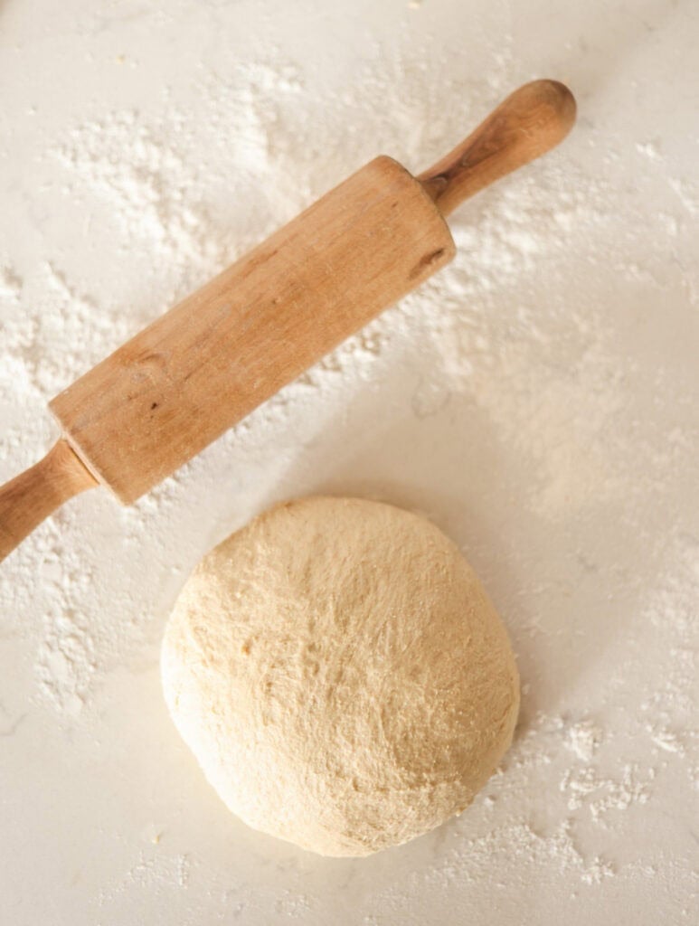 rises pullman loaf dough on floured surface ready to roll and shape.