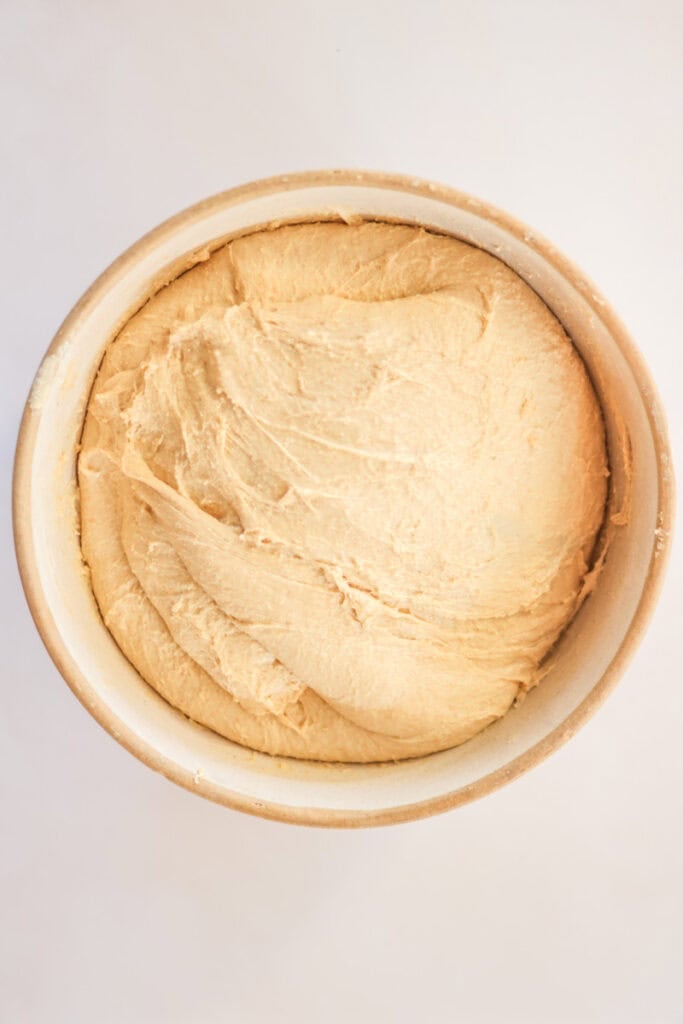 smooth, kneaded pullman loaf dough in a mixing bowl.