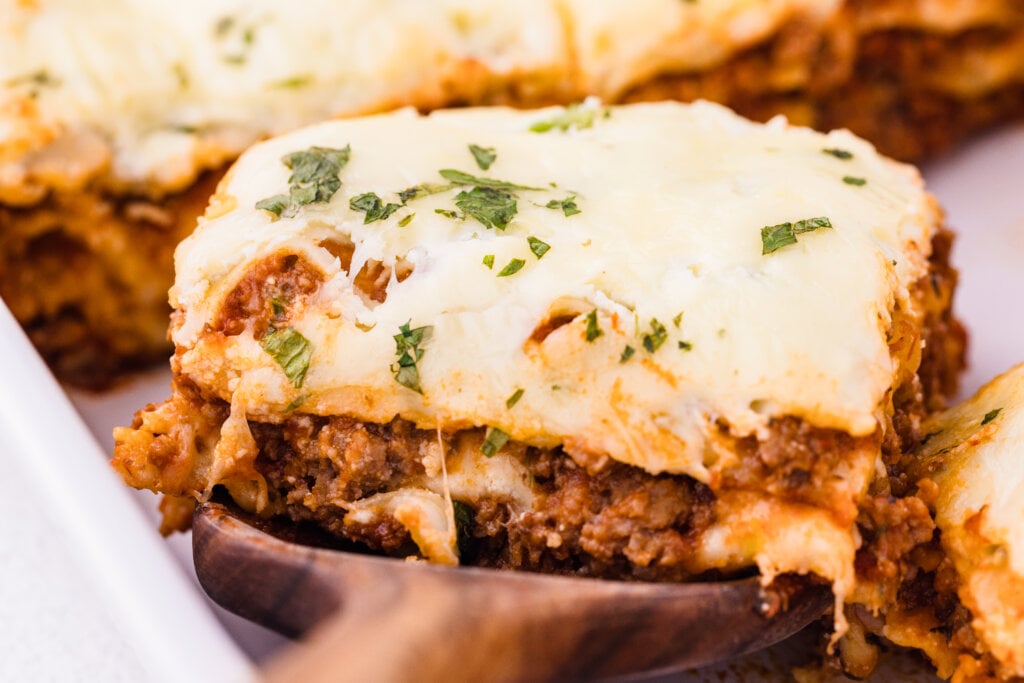 slice of lasagna with parsley on top