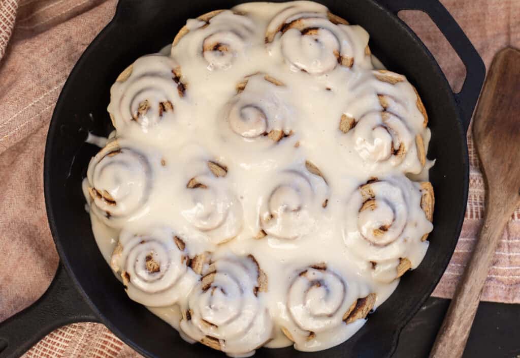 baked sourdough cinnamon rolls with cream cheese frosting.