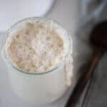 bubbly sourdough starter overflowing out of jar.