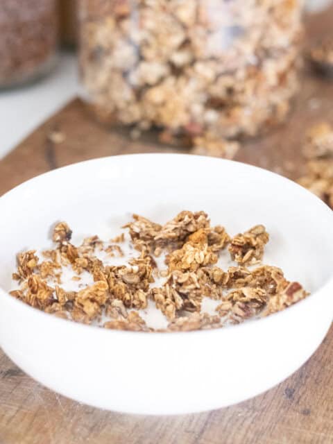 sourdough granola in bowl with milk.