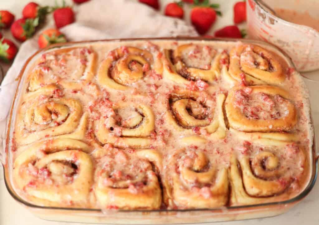 strawberry sourdough cinnamon rolls with strawberry glaze.