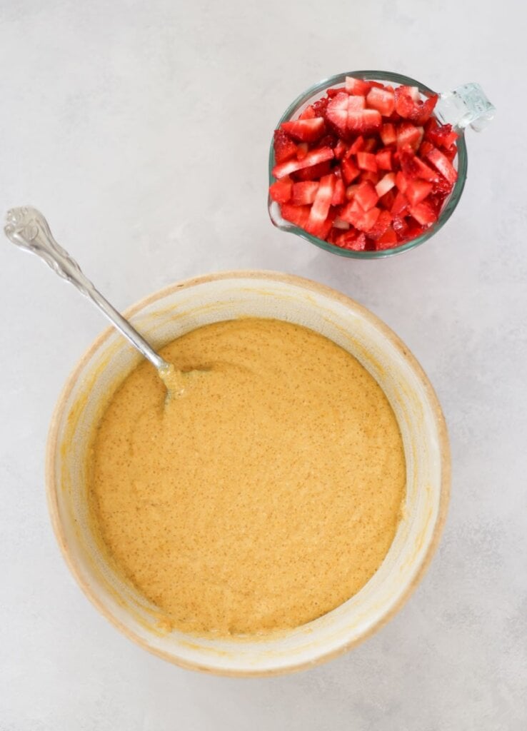 batter in a bowl with diced strawberries