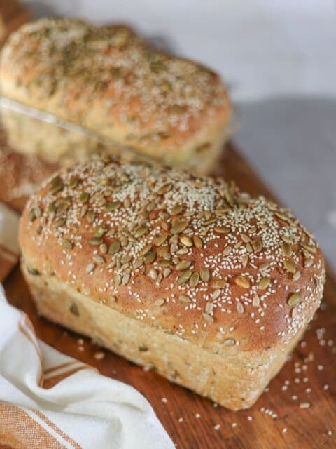 two seeded sourdough sandwich bread loaves.