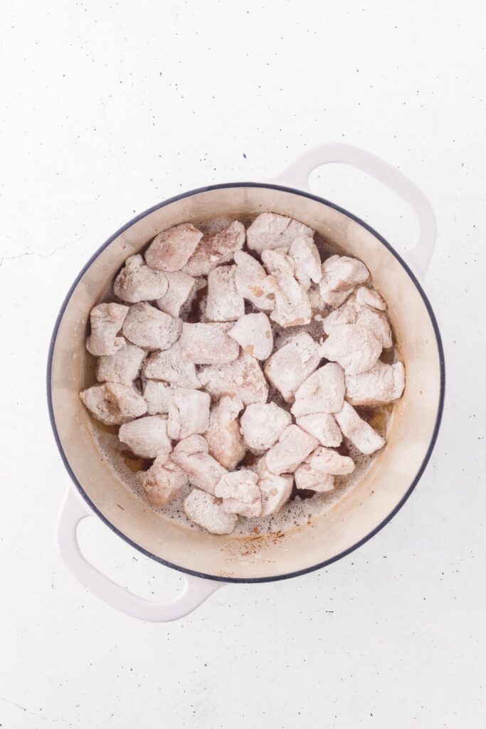 breaded chicken pieces added to skillet