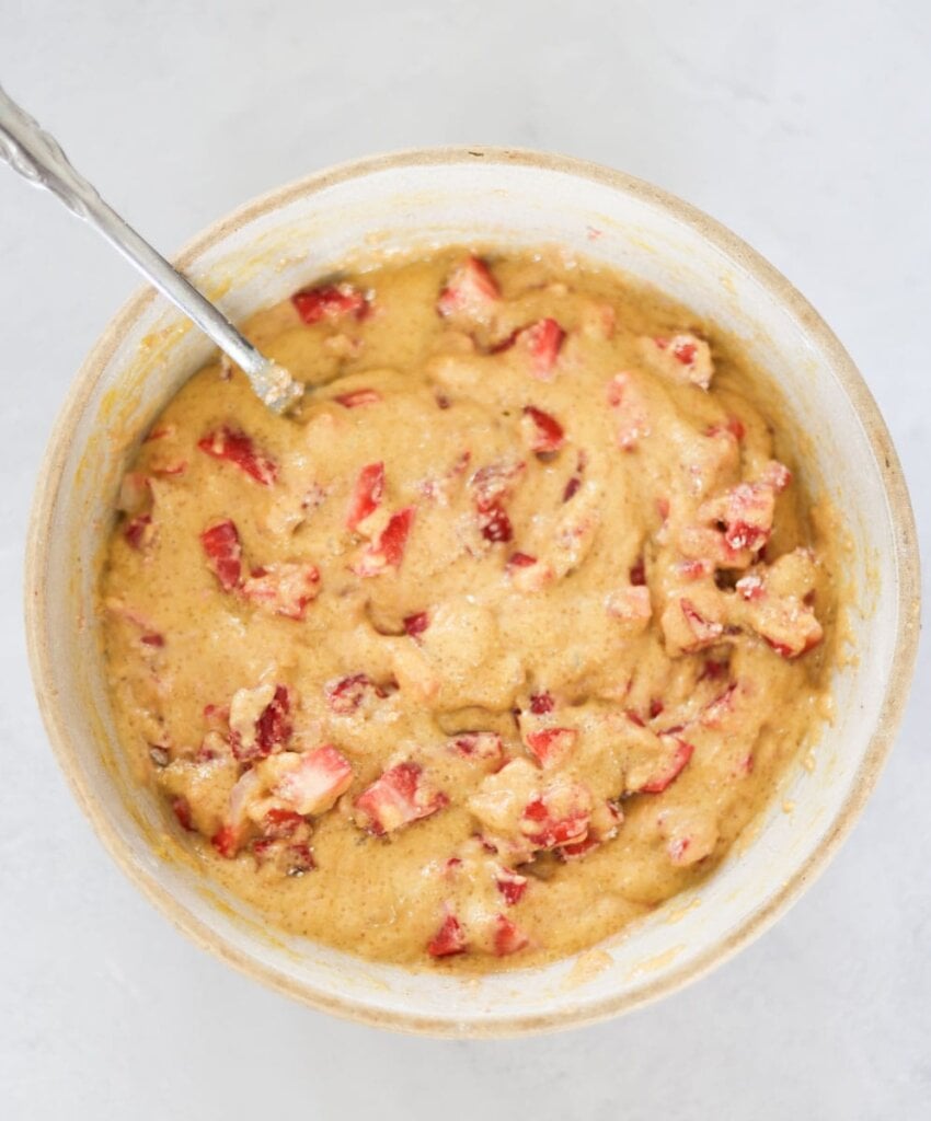 strawberry and batter mixed together in a bowl