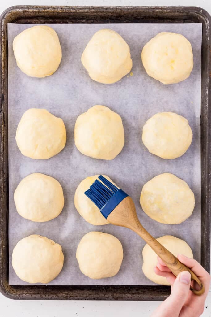 brushing egg wash onto the dough