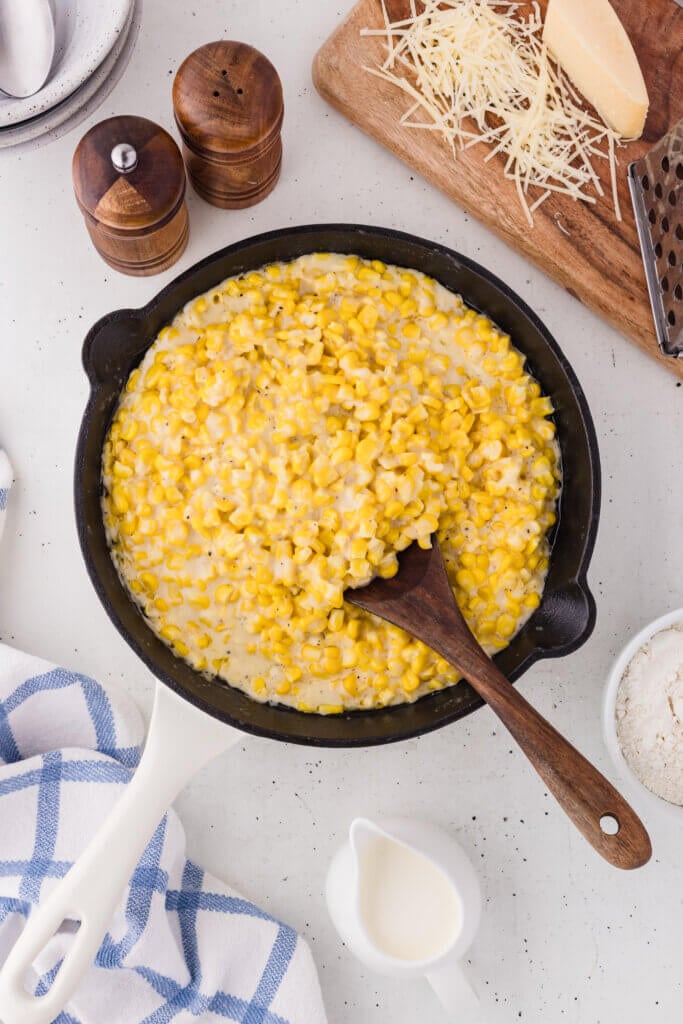 creamed corn in a cast iron skillet pan