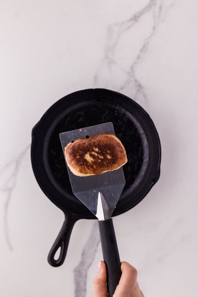 frying a beignet on a skillet pan