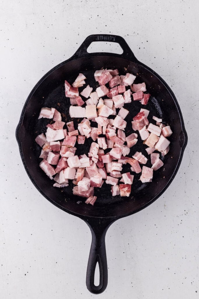 frying diced bacons in a skillet