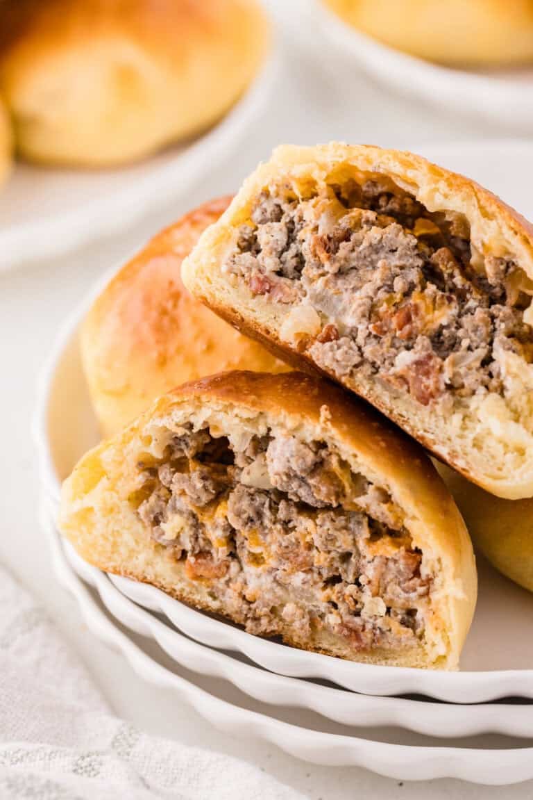 sourdough kolaches in half showing its cheeseburger filling
