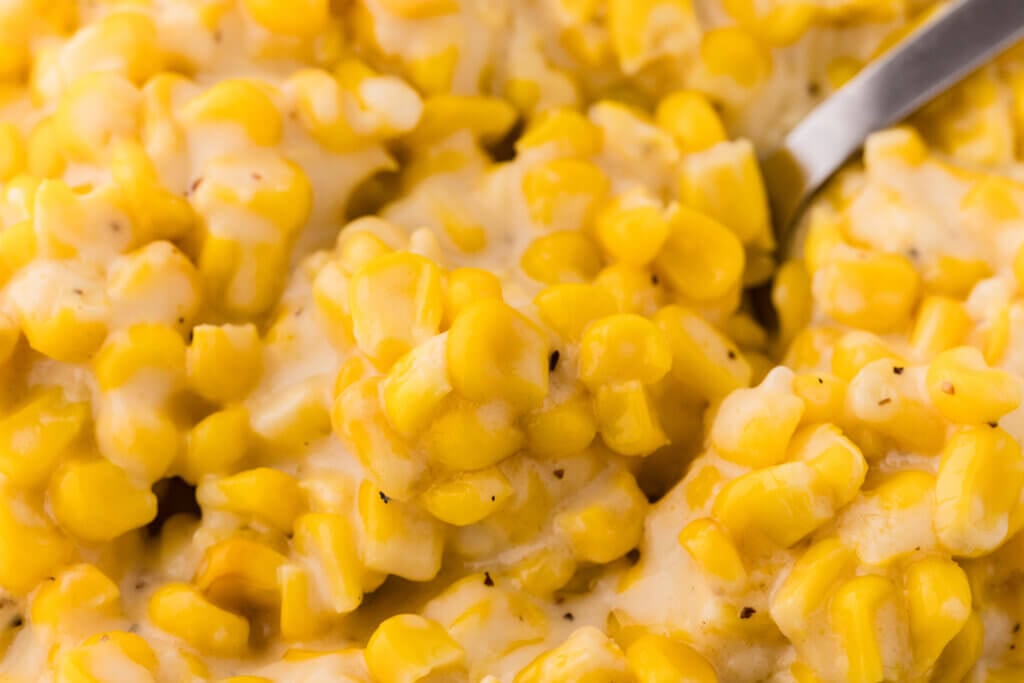 a spoon full of cream corn from scratch