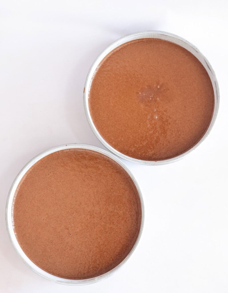 chocolate cake batter in two 9 inch cake pans.