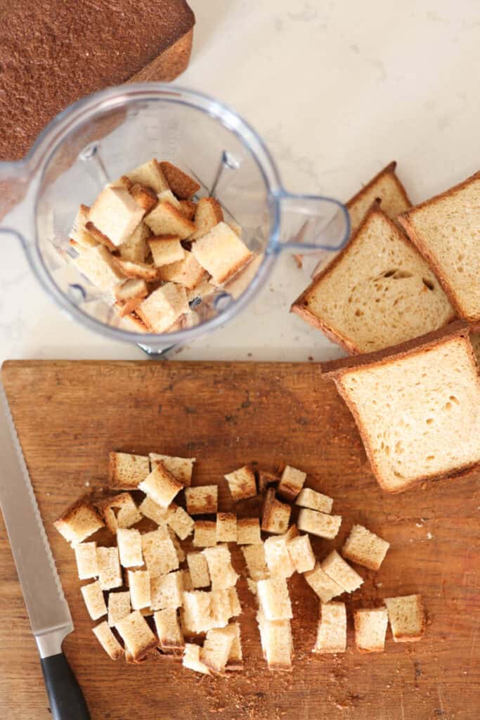 sourdough bread sliced and cubed then placed in blender for breadcrumbs.