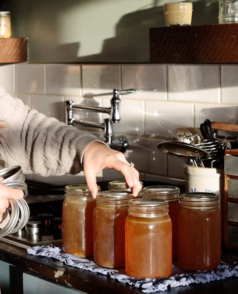 removing rings and checking seals on pressure canned jars of bone broth.