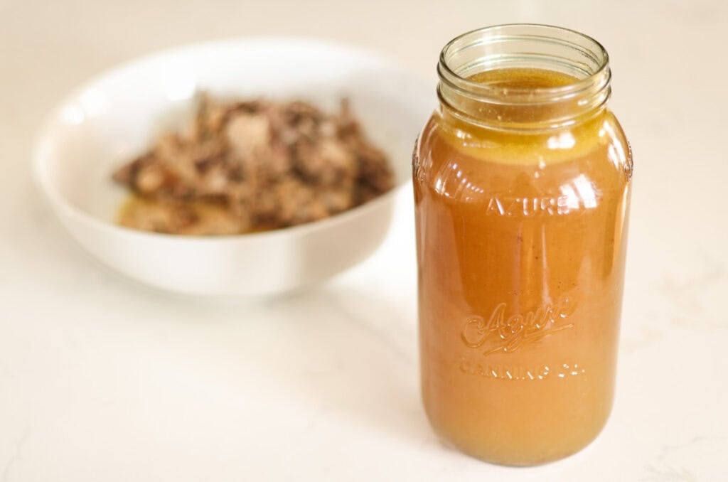 chicken bone broth recipe jar of golden bone broth.