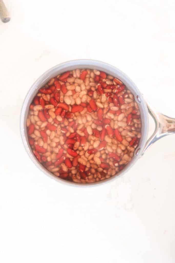 soaked dry beans added to pot of water to cook.