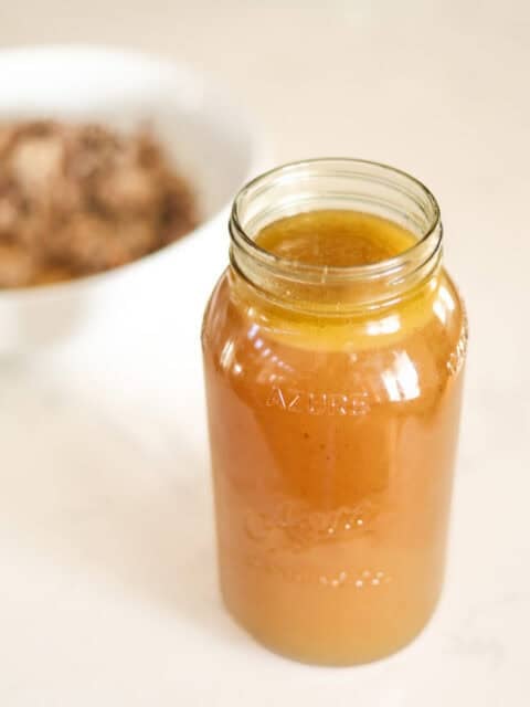 jar of golden chicken bone broth.