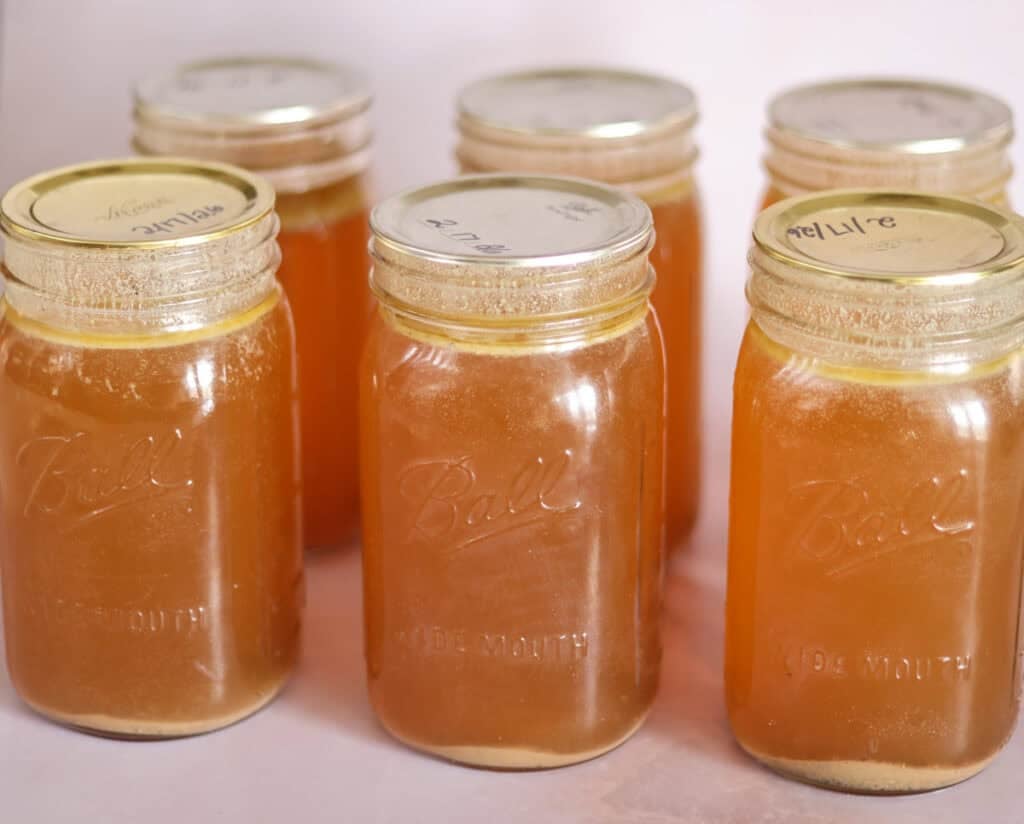 six quart jars of pressure canned chicken bone broth.