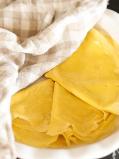 high protein egg wraps folded and stacked in pie plate.