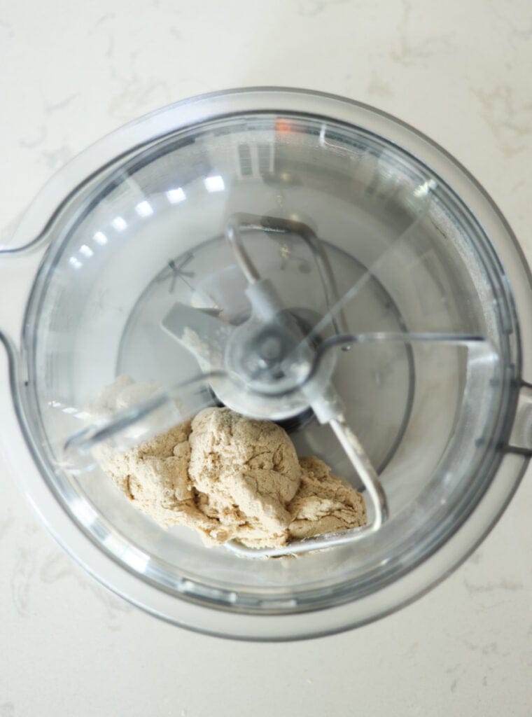 pizza dough in mixer bowl with dough hook.