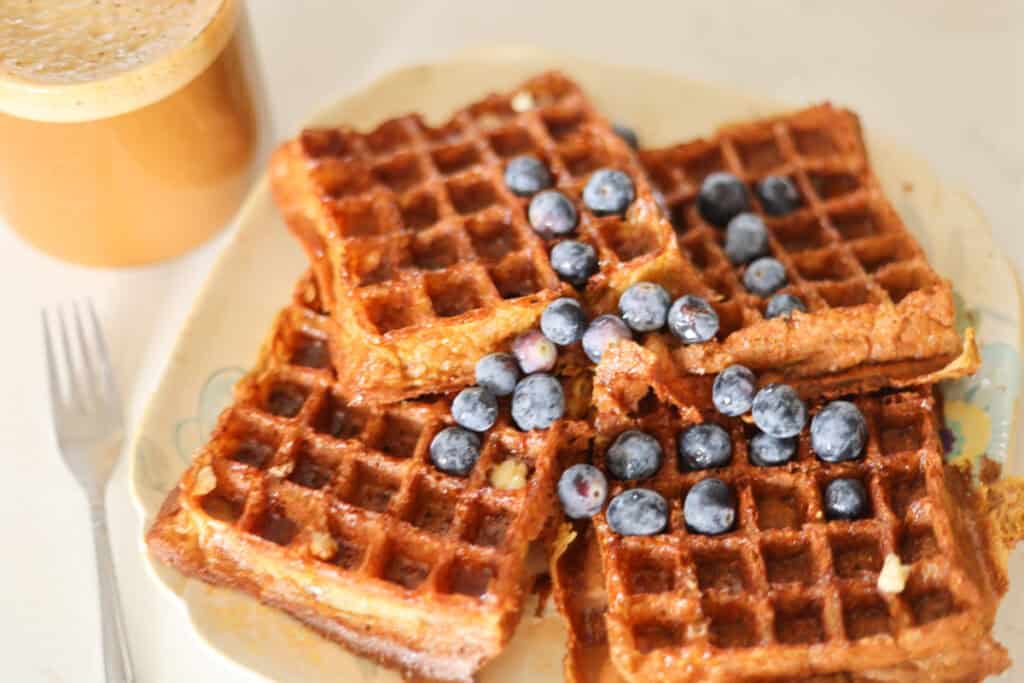 stack of sourdough protein waffles with fresh blueberries.