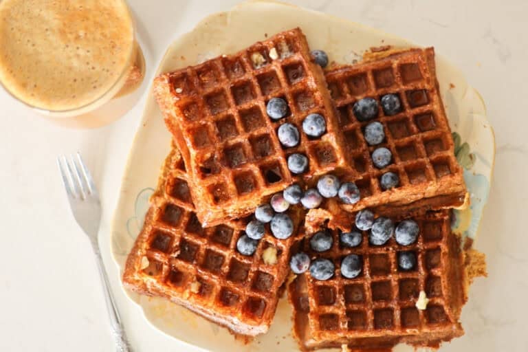 plate of sourdough belgian waffles with fresh blueberries.
