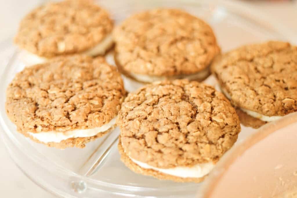 five peanut butter oatmeal cream pies on serving plate.